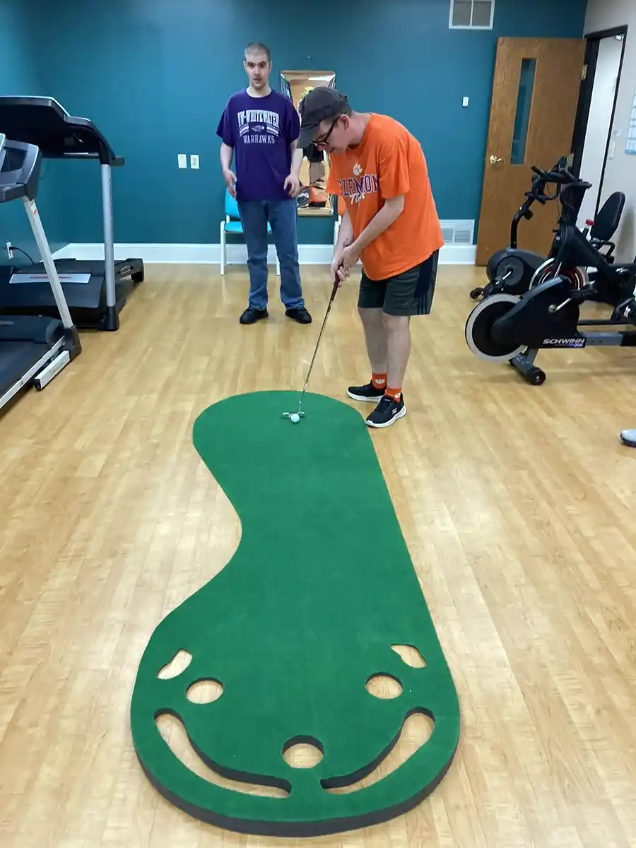 Participants playing mini golf
