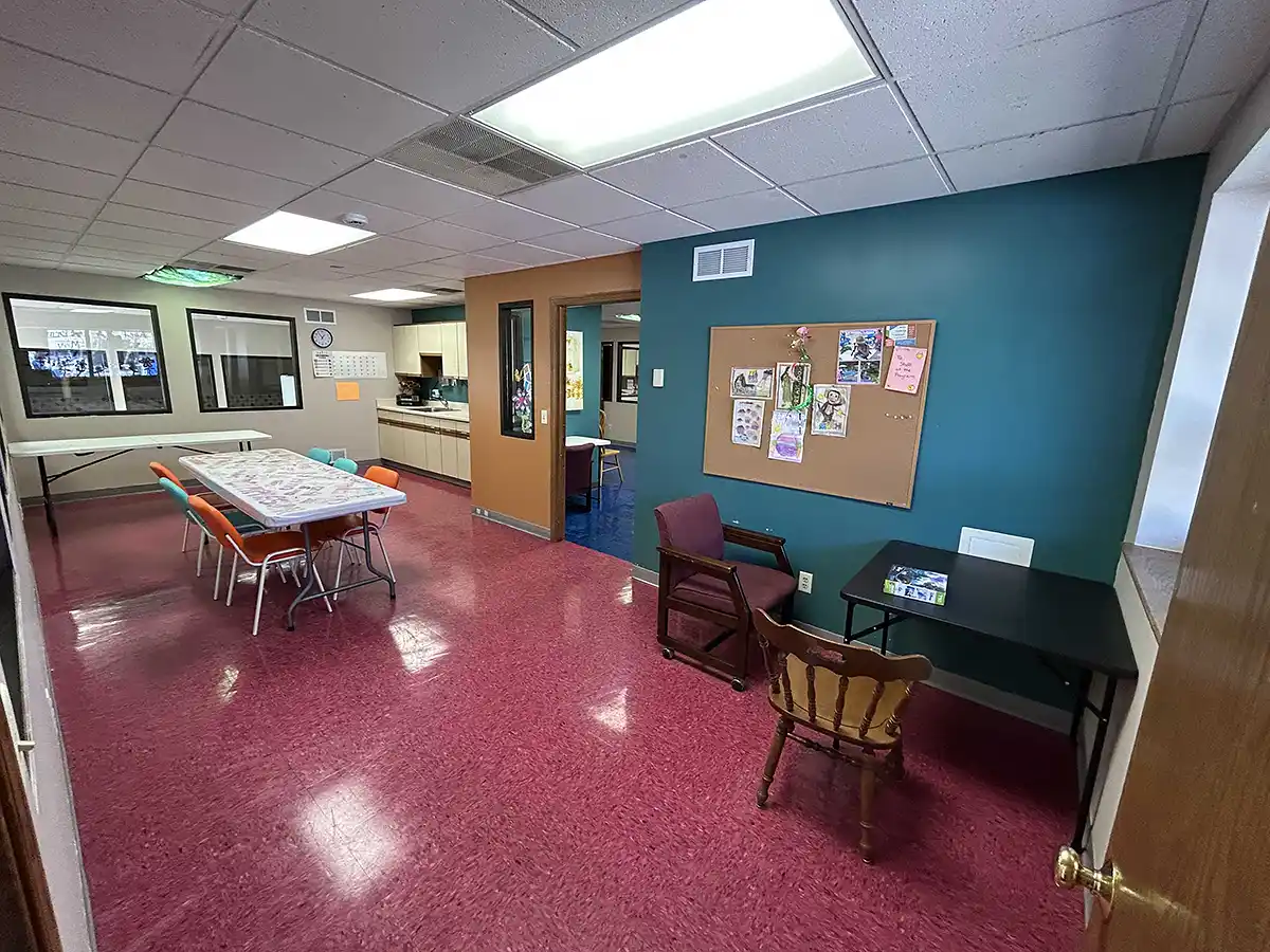Open activity room with tables and seating